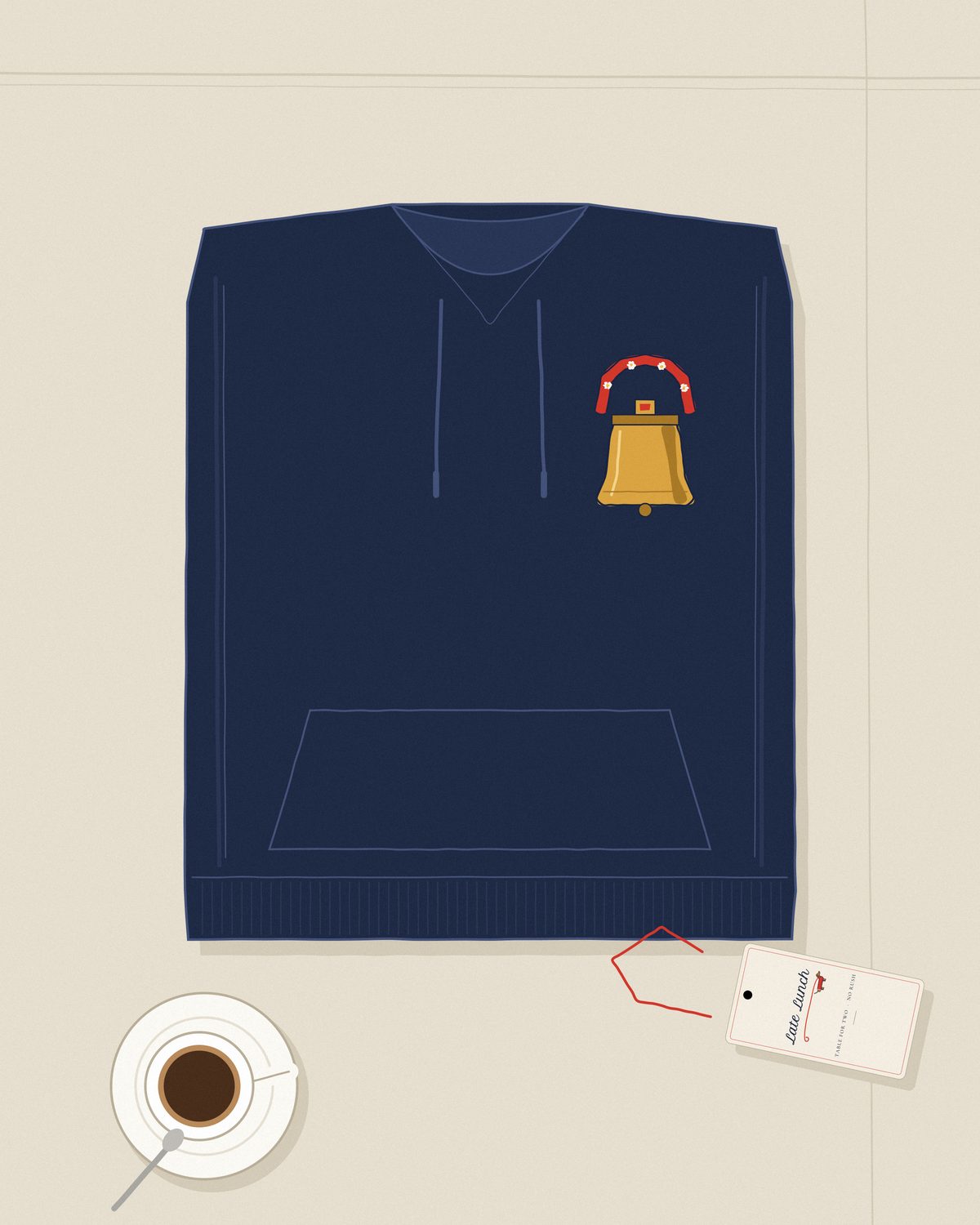 The navy Gstaad hoodie folded on linen, the cowbell on the chest, an espresso and the bill beside it.